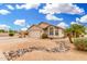 Beautiful desert-landscaped yard with mature palms adorns this single-story home with a two-car garage at 13137 W Wilshire Dr, Goodyear, AZ 85395