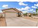 Single-story home with a two-car garage, bay windows, desert landscaping and a driveway at 13137 W Wilshire Dr, Goodyear, AZ 85395
