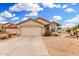 Charming single-story home featuring a two-car garage, desert landscaping, and a tile roof at 13137 W Wilshire Dr, Goodyear, AZ 85395