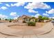 Inviting home featuring low-maintenance desert landscaping, mature palms, and a two-car garage at 13137 W Wilshire Dr, Goodyear, AZ 85395