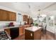 Well-lit kitchen with wood cabinets, granite countertops, and center island at 13137 W Wilshire Dr, Goodyear, AZ 85395