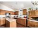Kitchen features wood cabinets, granite countertops, and stainless appliances at 13137 W Wilshire Dr, Goodyear, AZ 85395