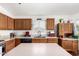 Kitchen with center island, wood cabinets and granite countertops at 13137 W Wilshire Dr, Goodyear, AZ 85395