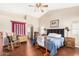 Inviting main bedroom featuring a ceiling fan, and an ensuite bathroom at 13137 W Wilshire Dr, Goodyear, AZ 85395