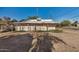 Image of the rear of the property and a dirt yard with a detached structure at 1438 S 112Th Ave, Avondale, AZ 85323