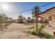 Expansive backyard featuring a palm tree, shed, and weathered awning at 1438 S 112Th Ave, Avondale, AZ 85323