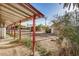 View of backyard area with covered patio, dirt landscaping and shed in the distance at 1438 S 112Th Ave, Avondale, AZ 85323