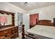Bedroom featuring dark wood furniture including a dresser and bed frame at 1438 S 112Th Ave, Avondale, AZ 85323