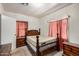Bedroom featuring wood furniture including a bed frame and dresser with visible windows at 1438 S 112Th Ave, Avondale, AZ 85323