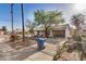 Charming single-story home with covered front porch and mature trees at 1438 S 112Th Ave, Avondale, AZ 85323