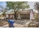 Charming single-story home with covered front porch and mature trees at 1438 S 112Th Ave, Avondale, AZ 85323