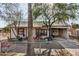 Charming single-story home with a covered front porch and mature trees at 1438 S 112Th Ave, Avondale, AZ 85323