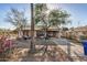 Charming single-story home with a covered front porch and mature trees at 1438 S 112Th Ave, Avondale, AZ 85323