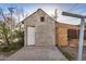 Outbuilding with peeling stucco and plywood window coverings, concrete slab at 1438 S 112Th Ave, Avondale, AZ 85323