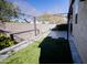 Serene backyard with artificial grass, a stone wall and modern metal canopy for relaxation and outdoor enjoyment at 15424 N 22Nd Ln, Phoenix, AZ 85023