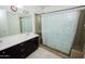 This bathroom features a double vanity with white countertops and dark cabinetry at 15424 N 22Nd Ln, Phoenix, AZ 85023