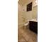 Well-lit bathroom with a tub/shower combo, tile flooring, and vanity with sink at 15424 N 22Nd Ln, Phoenix, AZ 85023