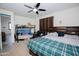This bedroom has a bed with a green plaid comforter, along with a bunk bed and comfy leather armchair at 15424 N 22Nd Ln, Phoenix, AZ 85023
