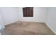 Bedroom featuring carpet, windows with shutters and white walls with door ajar at 15424 N 22Nd Ln, Phoenix, AZ 85023