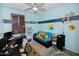 Bright bedroom with a ceiling fan, playful decor, and desk area, offering a comfortable and creative space at 15424 N 22Nd Ln, Phoenix, AZ 85023