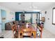 Dining area features a wooden table with seating for six, a modern chandelier, and access to other living areas at 15424 N 22Nd Ln, Phoenix, AZ 85023
