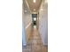 Hallway with tile flooring offers natural light from a window at the end of the hall at 15424 N 22Nd Ln, Phoenix, AZ 85023