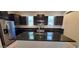 Modern kitchen features a large island, stainless steel appliances, and dark cabinetry at 15424 N 22Nd Ln, Phoenix, AZ 85023
