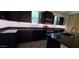 Well-equipped kitchen featuring dark cabinetry, black countertops, stainless steel appliances, and tiled floors at 15424 N 22Nd Ln, Phoenix, AZ 85023