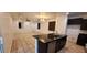 Open concept featuring a spacious kitchen island with dark cabinetry and granite countertops at 15424 N 22Nd Ln, Phoenix, AZ 85023