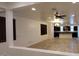Spacious living room featuring tile flooring, ceiling fan, and seamless transition to the kitchen space at 15424 N 22Nd Ln, Phoenix, AZ 85023