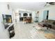 Open floor plan with tile flooring, a modern ceiling fan, and a view towards the dining area and kitchen at 15424 N 22Nd Ln, Phoenix, AZ 85023