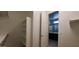 Walk-in closet with shelving leading to a bathroom, offering convenience and functionality at 15424 N 22Nd Ln, Phoenix, AZ 85023