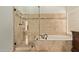 Bathroom boasts a glass-enclosed shower, soaking tub, and neutral tile at 15430 N 19Th Way, Phoenix, AZ 85022