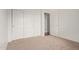 A tidy bedroom with a closet featuring sliding doors and light-colored carpet at 15430 N 19Th Way, Phoenix, AZ 85022