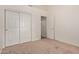 A spacious bedroom with large closets, plush carpet, and white trim at 15430 N 19Th Way, Phoenix, AZ 85022