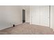 Clean, carpeted bedroom with a large closet featuring sliding doors for easy storage at 15430 N 19Th Way, Phoenix, AZ 85022