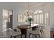 Elegant dining room with tile floors, chandelier, and dining table set for a dinner party at 15430 N 19Th Way, Phoenix, AZ 85022