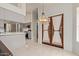 Dining area with a view into the modern kitchen and double doors with sheer curtains at 15430 N 19Th Way, Phoenix, AZ 85022