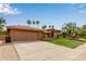 Inviting home featuring a red tile roof, arched windows, desert landscaping, and well-manicured lawn at 15430 N 19Th Way, Phoenix, AZ 85022