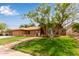 Inviting home featuring a red tile roof, arched windows, desert landscaping, and well-manicured lawn at 15430 N 19Th Way, Phoenix, AZ 85022