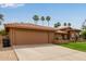 Inviting home featuring a red tile roof, arched windows, desert landscaping, and well-manicured lawn at 15430 N 19Th Way, Phoenix, AZ 85022