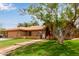 Inviting home featuring a red tile roof, arched windows, desert landscaping, and well-manicured lawn at 15430 N 19Th Way, Phoenix, AZ 85022