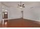 Bright living room featuring hardwood floors, ceiling fan, and front door with beautiful glass features at 15430 N 19Th Way, Phoenix, AZ 85022