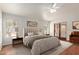 Digitally staged main bedroom with a queen bed, neutral decor, and access to the backyard at 15430 N 19Th Way, Phoenix, AZ 85022