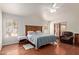 Well-lit main bedroom featuring a ceiling fan, hardwood floors, and access to the backyard at 15430 N 19Th Way, Phoenix, AZ 85022