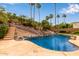 Beautiful pool with a slide, set amidst desert landscaping and towering palm trees at 15430 N 19Th Way, Phoenix, AZ 85022