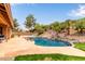 Backyard pool featuring desert landscaping, mature palms, a waterslide and expansive stone patio at 15430 N 19Th Way, Phoenix, AZ 85022
