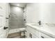 Stylish bathroom featuring a tiled shower and a modern vanity with marble countertops at 16025 E Rancho Laredo Dr, Scottsdale, AZ 85262