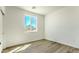 Bright, vacant bedroom with wood floors and large windows offering desert views at 16025 E Rancho Laredo Dr, Scottsdale, AZ 85262