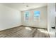 Well-lit bedroom with wood floors and a view of the desert from the windows at 16025 E Rancho Laredo Dr, Scottsdale, AZ 85262